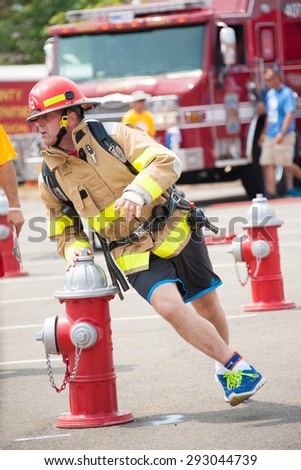 FAIRFAX, VA - JULY 3: A competitor runs the obstacle course in the Ultimate Firefighter competition at the World Police & Fire Games on July 3, 2015