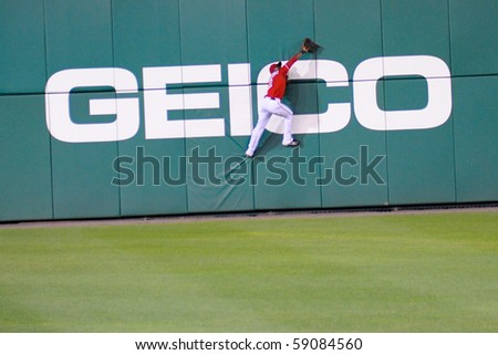 WASHINGTON - AUGUST 14: Roger Bernadina of the Washington Nationals attempts a catch at the wall in the Nationals\' home game against the Arizona Diamondbacks on August 14, 2010 in Washington.