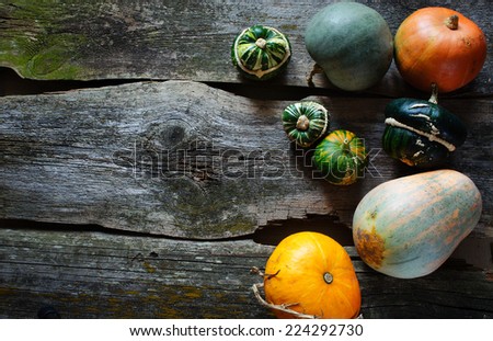 pumpkins with a copy space for note or congratulations on the old wooden background