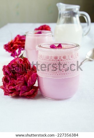 healthy breakfast - Rose flavor homemade yogurt in a glass jar decorated with lace