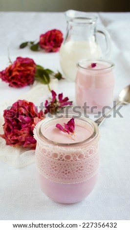 healthy breakfast - Rose flavor homemade yogurt in a glass jar decorated with lace