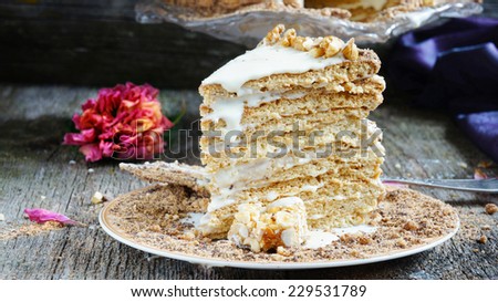 honey cake with many layers on the old wooden background, in rustic style