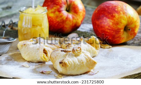 puff pastries with apple jam on the old wooden background