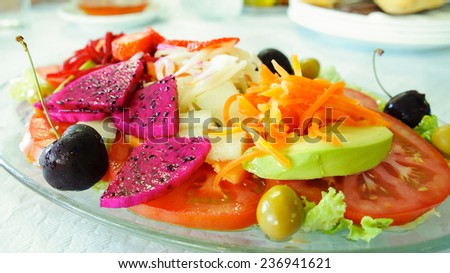 exotic salad with Pitahaya, avocado, tomatoes and beets, olives, cherries and strawberries in a cafe in Tenerife
