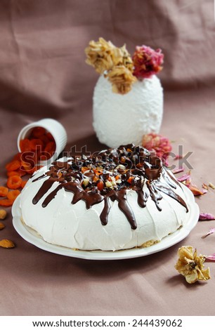 Pavlova cake with prunes, nuts and chocolate