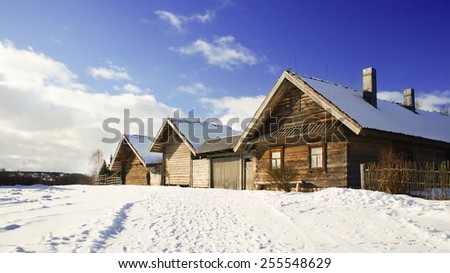 Old wooden houses in winter, Minsk region, Ozertso village, Belarus