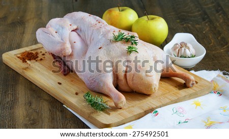 duck raw on the cutting board with apples