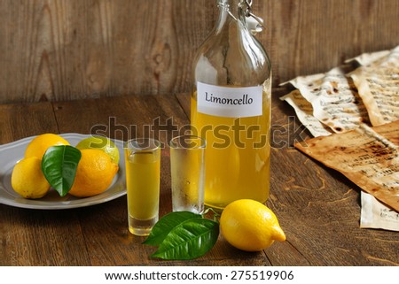 Limoncello  - homemade Italian alcoholic beverage, on wooden table