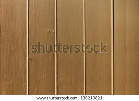 A close up of wood paneling on an interior or exterior wall.