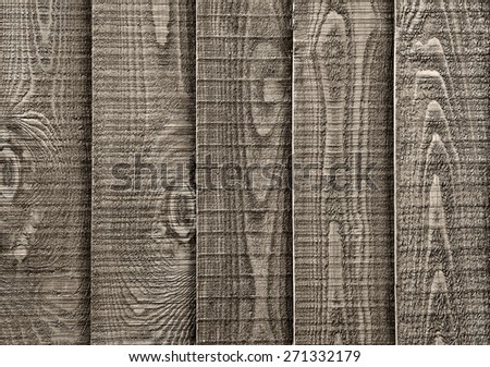 A close up section of  weathered wooden garden fencing with vertical, overlapped panels.