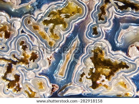 A close up of  crazy lace agate mineral gemstone with onyx for use as a design element