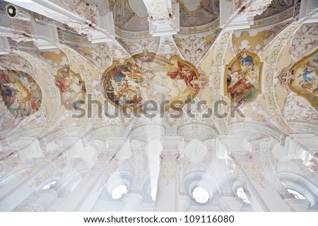 MUNICH, GERMANY - OCTOBER 23, 2011: Ceiling of the  Heiliggeistkirche church in Munich, Germany at October 23, 2011.  In the interior there are Rococo frescoes and stucco ornament by the Asam brothers