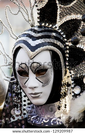 VENICE, ITALY - FEBRUARY 9: Unidentified person with traditional Venetian carnival mask in Venice, Italy at February 9, 2013. At 2013 it is held from January 26th to February 12th.