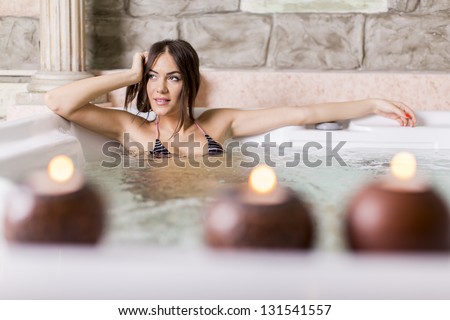 Young woman relaxing in the hot tub