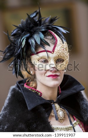 VENICE, ITALY - FEBRUARY 9: Unidentified person with traditional Venetian carnival mask in Venice, Italy at February 9, 2013. At 2013 it is held from January 26th to February 12th.