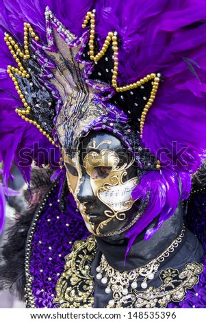 VENICE, ITALY - FEBRUARY 9: Unidentified person with Venetian carnival mask in Venice, Italy at February 9, 2013. At 2013 it is held from January 26th to February 12th.