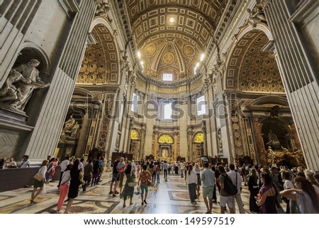 VATICAN - JULY 19: People at the interior of the Saint Peter Cathedral in Vatican at July 19, 2013. Saint Peter\'s Basilica has the largest interior of any Christian church in the world.