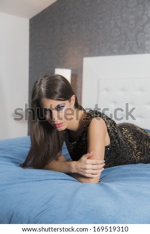 Pretty young woman on the bed