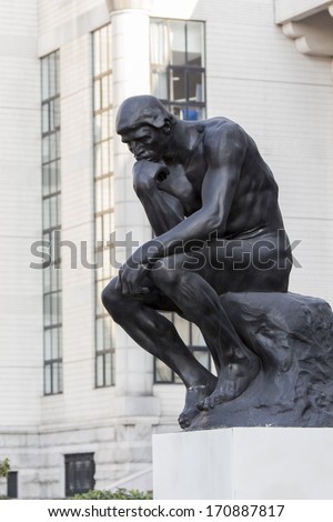 SHANGHAI, CHINA - DECEMBER 10, 2013: The Large Thinker sculpture in front of Shanghai library on Huaihai Road. It is made of one of 5 original plaster molds made by Rodin and was inaugurated at 2004.