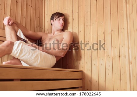 Young man relaxing in the sauna