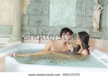 Young couple relaxing in the hot tub
