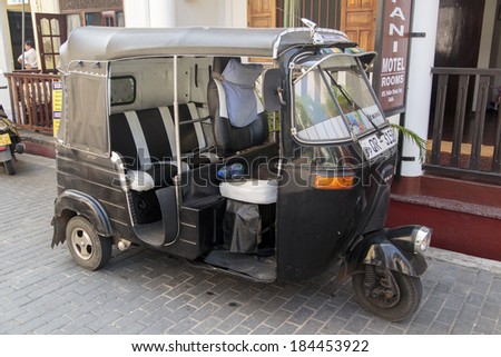GALLE, SRI LANKA - JANUARY 24, 2014: Auto rickshaw or tuk-tuk on the street of Galle. Most tuk-tuks in Sri Lanka are a slightly modified Indian Bajaj model, imported from India.