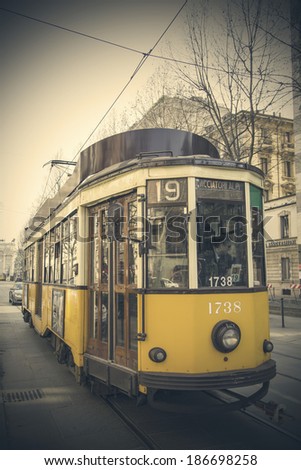 MILAN, ITALY - MARCH 8, 2014: Tram on the street of Milan. Milan Tramway Network In operation since 1881 and the network is now about 115 km long