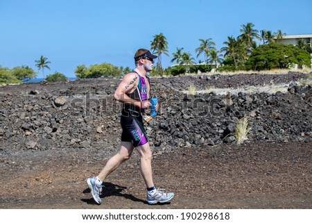WAIKOLOA, HI USA - APRIL 3, 2011: Unidentified runner on the Lavaman Triathlon in Waikoloa, Hawaii. It is held in Olympics format: 1.5 km swimming, 40 km biking and 10 km running.