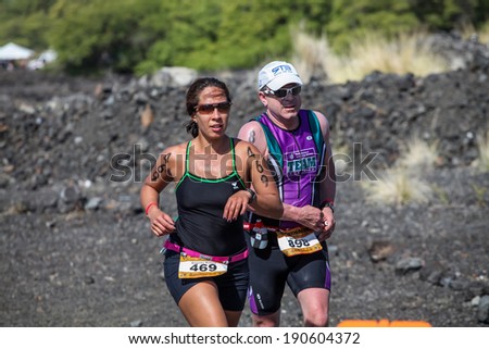 WAIKOLOA, USA - APRIL 3, 2011: Unidentified runners on the Lavaman Triathlon in Waikoloa, Hawaii. It is held in Olympics format: 1.5 km swimming, 40 km biking and 10 km running.