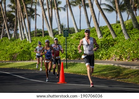 WAIKOLOA, USA - APRIL 3, 2011: Unidentified runners on the Lavaman Triathlon in Waikoloa, Hawaii. It is held in Olympics format: 1.5 km swimming, 40 km biking and 10 km running.