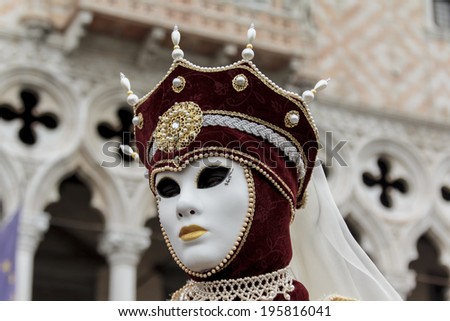 VENICE, ITALY - FEBRUARY 10, 2013: Unidentified person with Venetian carnival mask in Venice, Italy. At 2013 it is held from January 26th to February 12th.