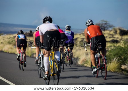 WAIKOLOA, USA - APRIL 3, 2011: Unidentified cyclers on the Lavaman Triathlon in Waikoloa, Hawaii. It is held in Olympics format: 1.5 km swimming, 40 km biking and 10 km running.