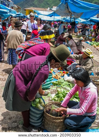 PISAC, PERU - MARCH 2, 2006: Unidentified people at the market in Pisac. It is a Peruvian village in the Sacred Valley. The village is well known for its market every Sunday, Tuesday, and Thursday.