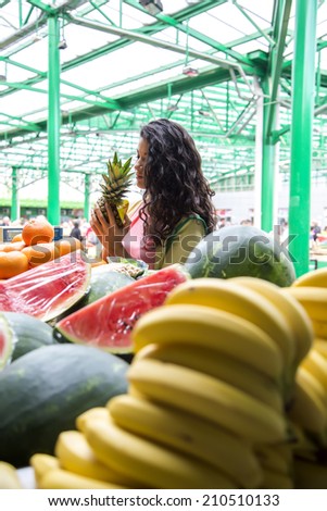 Young woman buying fruit at the market