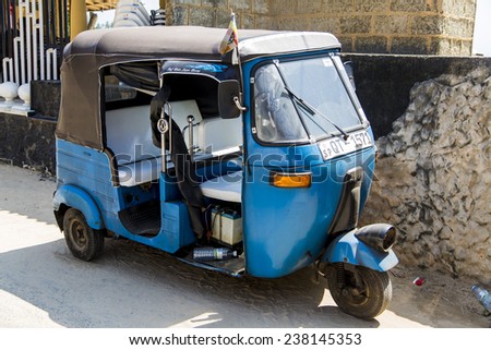 UNAWATUNA, SRI LANKA - JANUARY 23, 2014: Auto rickshaw or tuk-tuk on the street of Unawatuna. Most tuk-tuks in Sri Lanka are a slightly modified Indian Bajaj model, imported from India.
