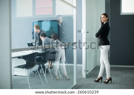 Young woman walking into office