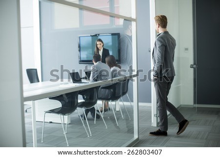 Young man walking into office