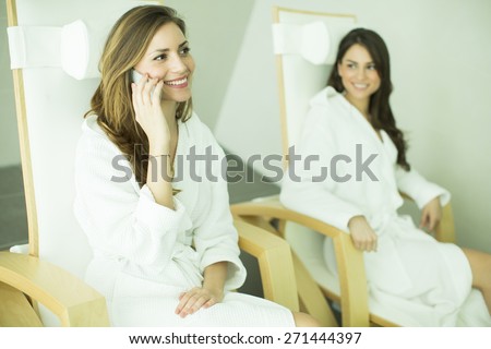 Young women in the spa center with mobile phone