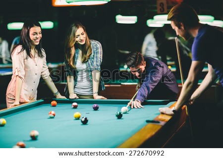 Young people playing pool