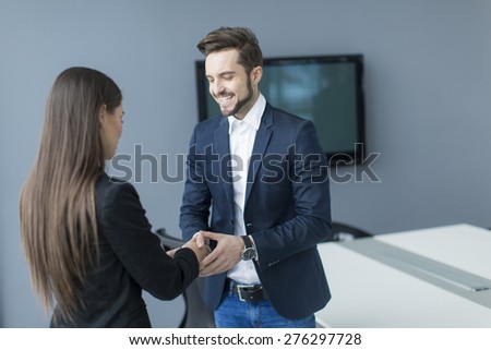 Man and woman handshaking in the office