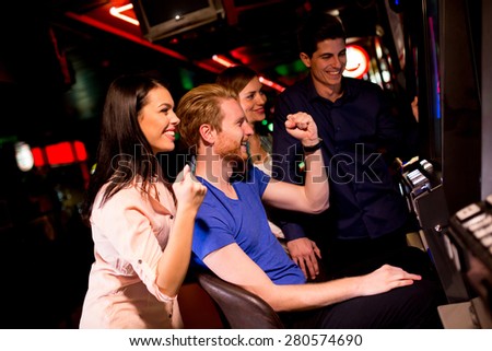 Young people at slot machine in the casino
