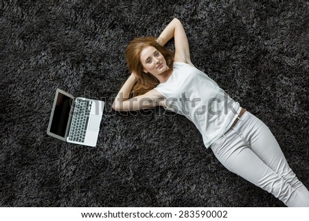 Young woman laying on the carpet