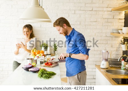 Couple cooking together in the kitchen at home