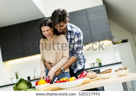 Lovely young couple preparing fresh food in the modern kitchen