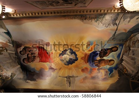 FIGUERES, SPAIN - JULY 27: Dali\'s bedroom in Dali Museum in Figueres, Spain at July 27, 2010. Ceiling painting in the room Palace of the Winds, featuring giant, barefoot figures of Dali and Gala.