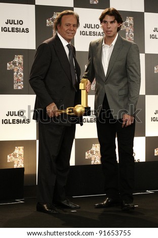MADRID-DECEMBER 12: R. Nadal gives awards to singer Julio Iglesias for the most albums sold in Spain and to the Latino singer with most albums sold in the world on December 12, 2011 in Madrid, Spain.