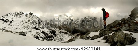 mountain climber looking over snowy peaks