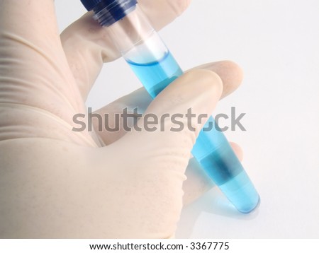 A test-tube with liquid in a human hand for medical analysis
