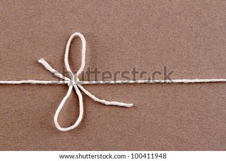 Tied knot on brown parcel