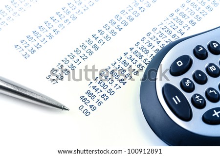 Closeup of financial figures, pen and calculator